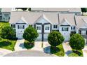 An aerial view of townhomes with well-manicured lawns and mature trees lining the driveways at 16 Daly Ct, Durham, NC 27705