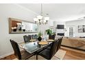 This dining area features a glass table with leather chairs and a decorative mirror and chandelier at 16 Daly Ct, Durham, NC 27705