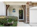 Charming entryway with stone accents, wood beams, and a welcoming 'Hello' doormat at 16 Daly Ct, Durham, NC 27705