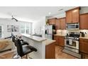 A well-lit kitchen showcases stainless steel appliances, granite countertops and hardwood floors at 16 Daly Ct, Durham, NC 27705