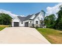 Stunning white two-story house with large driveway and attached two-car garage at 164 E Spring Showers Trail Trl, Angier, NC 27501