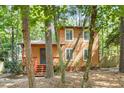 Charming two-story home with wood siding, front porch, and nestled among mature trees at 18 Frances St, Chapel Hill, NC 27517