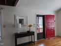 Foyer features a bright red front door, hardwood floors and a decorative table with a mirror at 18 Frances St, Chapel Hill, NC 27517