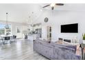 Open-concept living room with vaulted ceiling, seamlessly connecting the kitchen and dining area at 20 Ingate Way, Louisburg, NC 27549