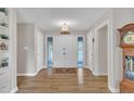 Inviting entryway with hardwood floors, neutral walls, and a classic grandfather clock, radiating warmth and charm at 2003 Ryerson Dr, Garner, NC 27529