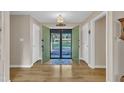 Bright foyer with hardwood flooring, complementing neutral walls, and offering a welcoming view to the outside at 2003 Ryerson Dr, Garner, NC 27529