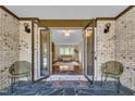 Inviting entryway features brick accents, stylish seating, and a glimpse into the home's bright, open living space at 2003 Ryerson Dr, Garner, NC 27529