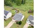 An aerial view showcasing the home, spacious backyard with fenced yard, and mature trees at 2012 Summer Shire Way, Raleigh, NC 27604