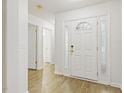 Bright entryway featuring a white front door with sidelights and wood-look flooring at 2012 Summer Shire Way, Raleigh, NC 27604