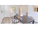 Well-lit dining room with black table, six chairs, and views of foyer and living areas at 2014 Athens Ave, Durham, NC 27707