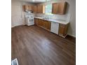 Spacious kitchen with light wood cabinets, white appliances, and vinyl flooring at 203 Hope St, Erwin, NC 28339