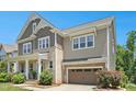 Attractive two-story home with a blend of brick and siding, a two-car garage, and beautiful landscaping at 205 Aurora Rd, Hillsborough, NC 27278