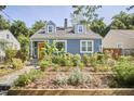 Charming two-story home with blue siding, a yellow front door, and a beautifully landscaped yard at 216 Northwood Cir, Durham, NC 27701