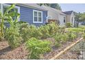 A lush front yard garden showcases healthy plants, mulch, and wood framing at 216 Northwood Cir, Durham, NC 27701