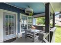 Inviting screened porch with comfortable seating, ceiling fan and tv, perfect for relaxing outdoors at 2214 Pathway Dr, Chapel Hill, NC 27516