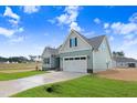 Well-maintained single-Gathering home with a nicely manicured lawn, an attached garage, and a private driveway at 222 Cherrybirch Ln, Zebulon, NC 27597