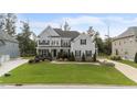Beautiful two-story home with manicured lawn, elegant landscaping, and gray siding at 228 Cloverdale Rd, Apex, NC 27523