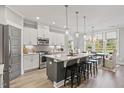Modern kitchen features stainless steel appliances, a center island with bar seating, and bright natural light at 23 W Victoria Ridge Dr # 33, Selma, NC 27576