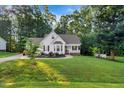 One-story home with front yard, a manicured lawn, mature trees, and a covered front porch at 240 Carrington Ave, Franklinton, NC 27525