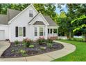 Well-maintained one-story home with a beautifully landscaped front yard and inviting walkway at 240 Carrington Ave, Franklinton, NC 27525