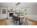 Bright dining area with a fireplace and large windows overlooking the yard at 2504 W Club Blvd, Durham, NC 27705