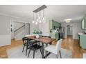 Elegant dining room with a modern light fixture and adjacent kitchen at 2504 W Club Blvd, Durham, NC 27705