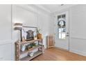 Bright foyer with stylish console table, decor, and front door with glass panels at 2806 High Plains Dr, Fuquay Varina, NC 27526