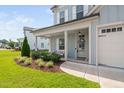 Inviting front porch with stylish decor and lush landscaping creating an appealing entrance at 2806 High Plains Dr, Fuquay Varina, NC 27526