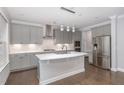 Modern kitchen with gray cabinets, stainless steel appliances, and quartz countertops at 2914 Farmhouse Dr, Apex, NC 27502