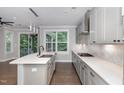 Bright kitchen featuring a center island with stainless steel sink, gas range, and natural light at 2914 Farmhouse Dr, Apex, NC 27502