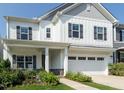 Charming two-story home with white siding, a covered porch, and a two-car garage at 365 Jorpaul Dr, Wake Forest, NC 27587