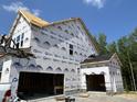 New two-car garage featuring craftsman style, still under construction at 386 Rising Star Dr, Clayton, NC 27520