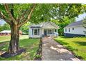 Charming exterior view showcasing the front yard and inviting facade of this lovely home with mature trees at 408 N Fourth/ 4Th St, Mebane, NC 27302