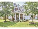 Attractive two-story home with landscaped yard, porch and a two-car garage at 418 Magna Dr, Durham, NC 27703
