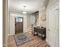 Inviting foyer with hardwood floors, staircase, and decorative table at 4416 Brighton Ridge Dr, Apex, NC 27539