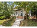 Inviting home with a covered front porch, well-manicured landscaping, and a classic design at 444 Claremont Dr, Chapel Hill, NC 27516