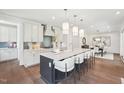 Bright kitchen boasts a large island with seating, modern lighting and views to the dining area at 45 Shady Creek Way, Fuquay Varina, NC 27526