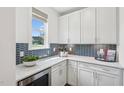 Charming butler's pantry with stylish backsplash, white countertops, and ample cabinet space at 45 Shady Creek Way, Fuquay Varina, NC 27526
