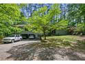 Wide view of the home's front exterior with an attached carport and mature landscaping at 4501 Zebulon Rd, Zebulon, NC 27597