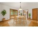 Cozy dining room showcasing hardwood floors, a stylish chandelier, and views into the screened porch and kitchen at 601 Wofford Rd, Durham, NC 27707
