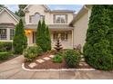 Stunning fountain with manicured landscaping leads to a welcoming porch on this lovely home at 602 Preston Village Way, Cary, NC 27519