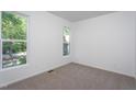 Bright bedroom with large windows offering plenty of natural light and neutral carpeting at 6069 Jones Cir, Sanford, NC 27332