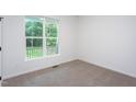 Cozy bedroom featuring a large window with outside view and neutral-toned carpet at 6069 Jones Cir, Sanford, NC 27332