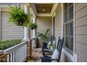 Cozy front porch featuring rocking chairs, ferns and stone accents for relaxing outdoors at 633 Rolling Springs Dr, Cary, NC 27519