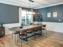 Spacious dining room features hardwood floors, a modern light fixture, and plenty of seating at 7502 Hedfield Way, Durham, NC 27713