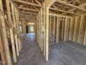 Interior framing of a new home showing the layout and stud walls, giving a sense of the floor plan at 76 Tuskeegee Dr, Smithfield, NC 27577