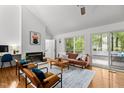 Bright living room with hardwood floors, fireplace, and access to the deck at 908 Cedar Fork Trl, Chapel Hill, NC 27514
