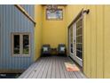 Charming outdoor deck features seating area and entry to the home's interior at 908 Cedar Fork Trl, Chapel Hill, NC 27514