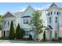 Charming two-story home with light blue siding, well-maintained landscaping, and mature trees on a sunny day at 979 Branch Line Ln, Apex, NC 27502
