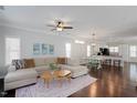 Bright living room features hardwood floors, a comfortable sectional sofa, and an open concept design at 979 Branch Line Ln, Apex, NC 27502